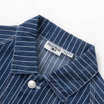 Close-up of a blue pinstripe shirt with a label on a white background