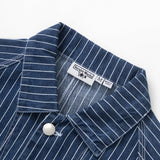 Close-up of a blue pinstripe shirt with a label on a white background