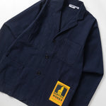 Navy jacket with a yellow label on a white background