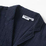 Navy textured jacket with a brand label on a white background