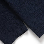 Close-up of a navy blue textured fabric on a white background