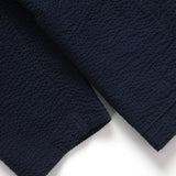 Close-up of a navy blue textured fabric on a white background