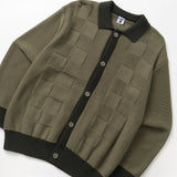 Green cardigan with black trim on a white background