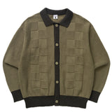 Green cardigan with black collar and cuffs on a white background
