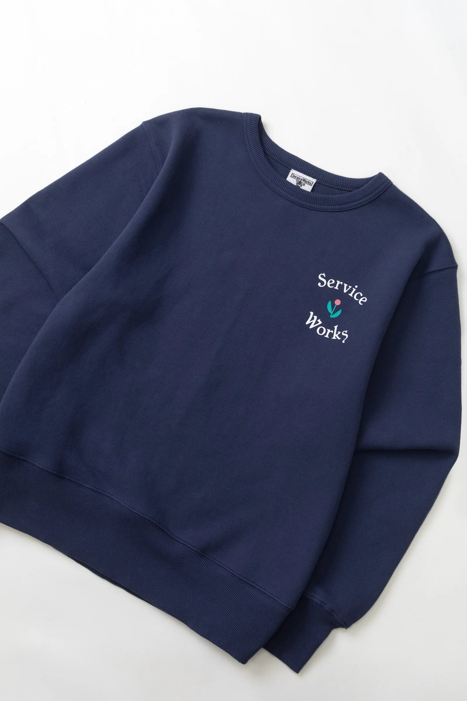 Navy blue sweatshirt with 'Service Works' logo on a white background