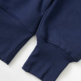 Close-up of a navy blue sweater sleeve on a white background