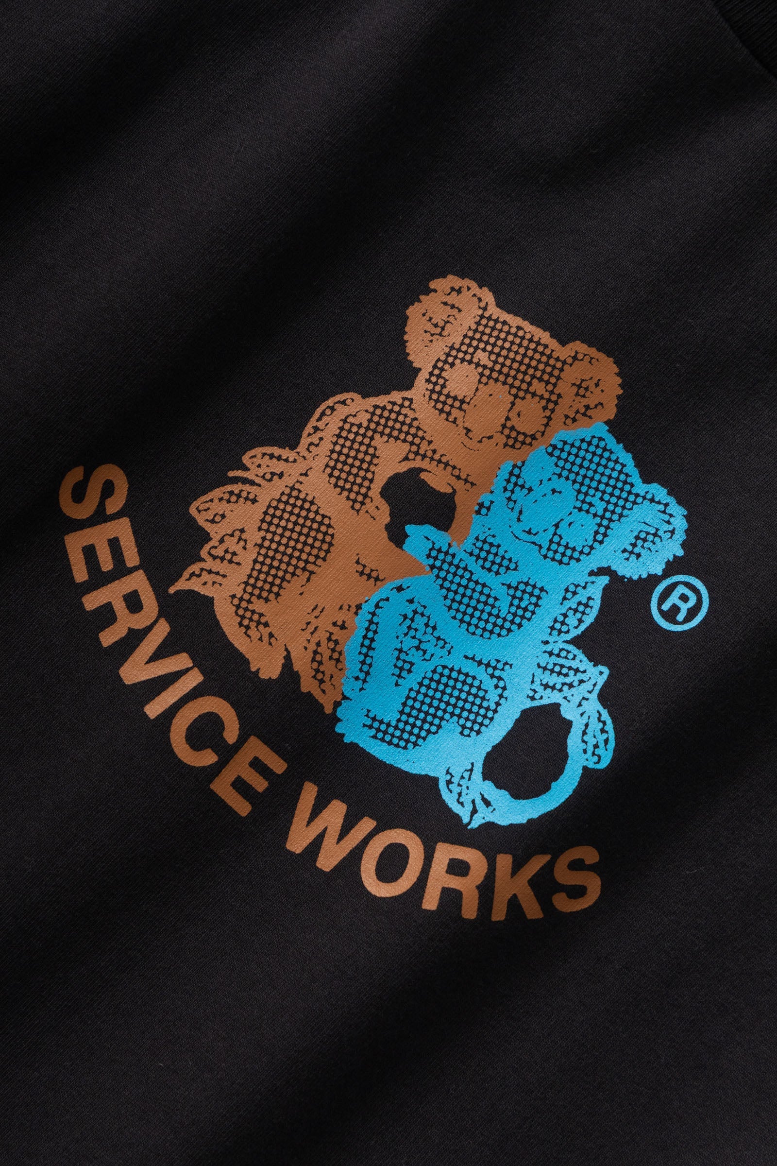 Black sweatshirt with brown and blue bear logo and 'Service Works' text.