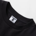 Black t-shirt with a small logo on a white background