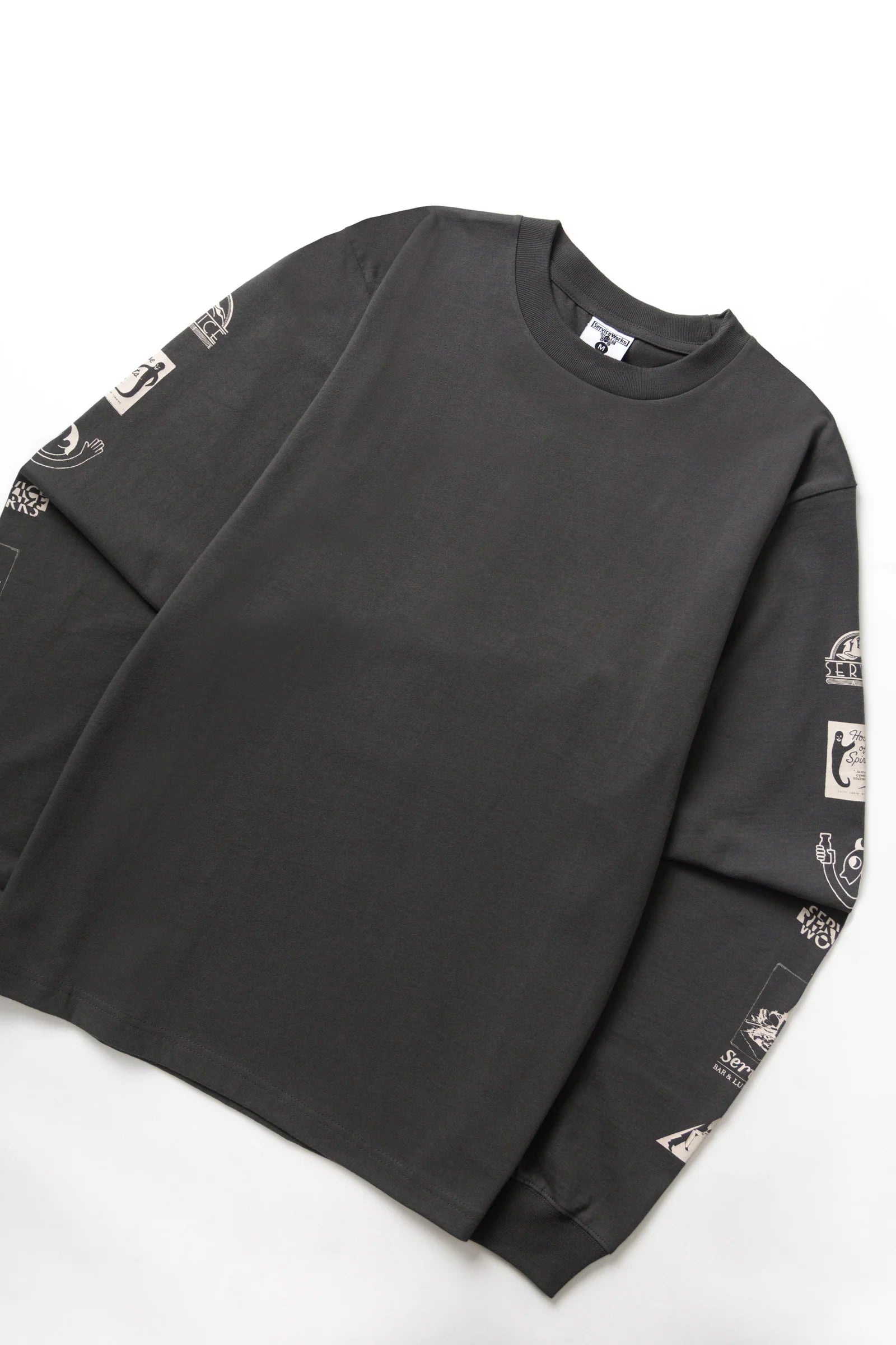 Black long-sleeve shirt with graphic designs on sleeves against a white background