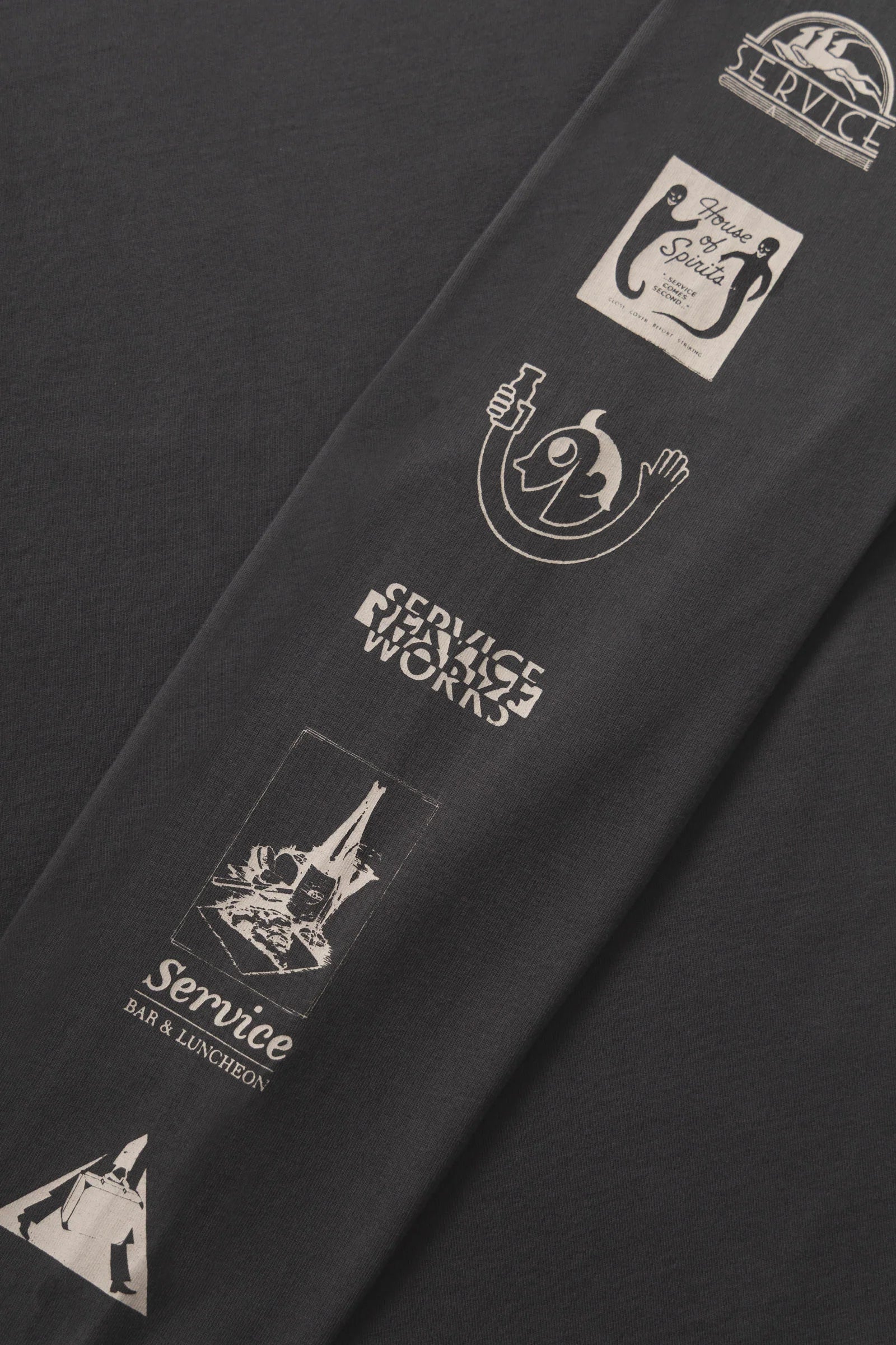 Black apron with white logos and text on a black background