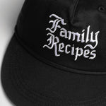 Black cap with 'Family Recipes' text on a light gray background