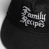 Black cap with 'Family Recipes' text on a light gray background