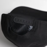 Black cap with a brand logo on the back against a white background