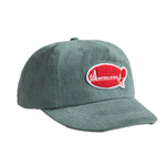 Green cap with a red and white logo on a white background