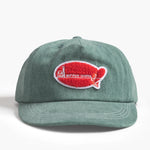 Green cap with a red and white logo on a white background