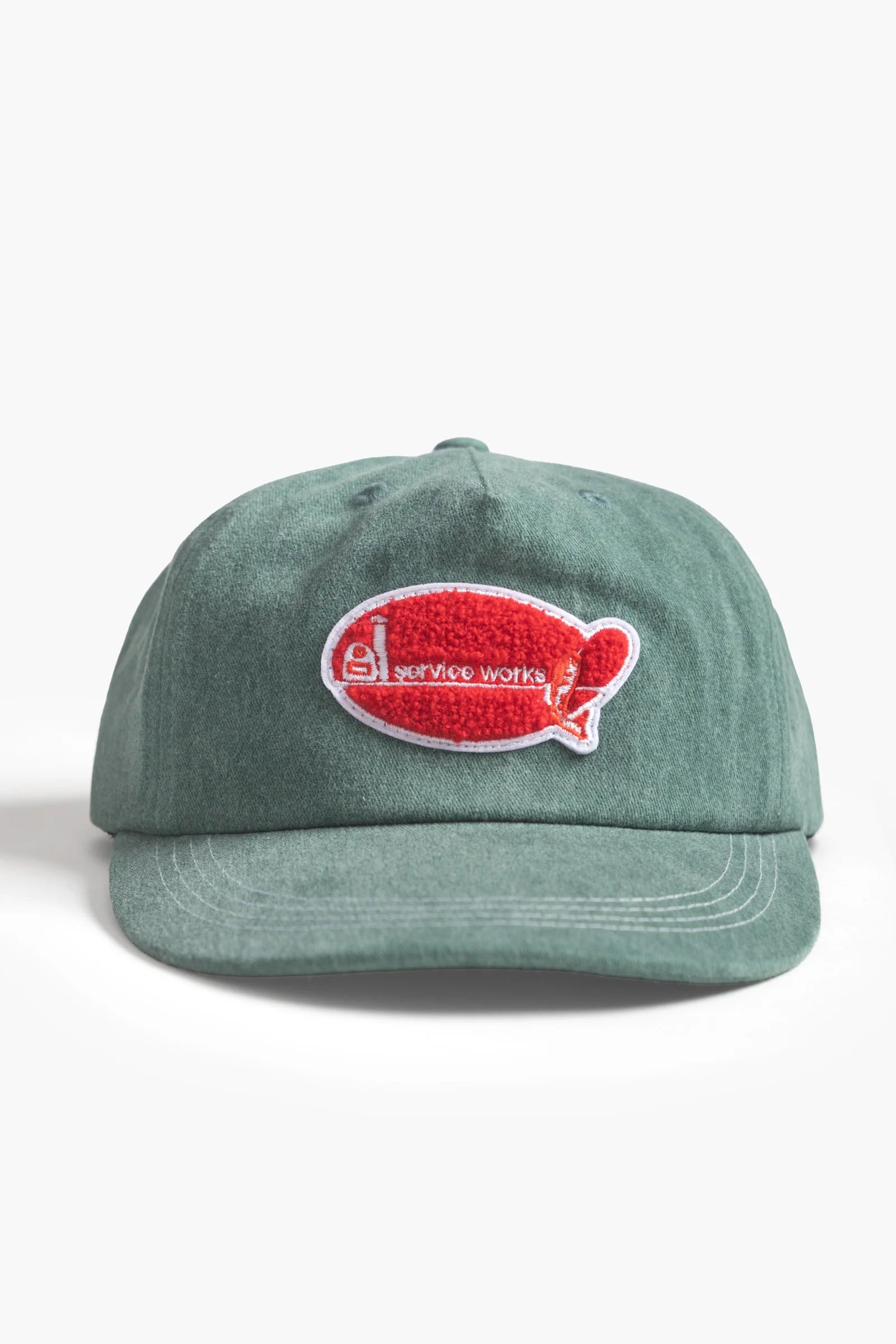 Green cap with a red and white logo on a white background