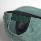Green cap with a textured surface on a white background