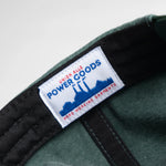 Green cap with a visible label on a light gray background