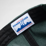 Green cap with a visible label on a light gray background