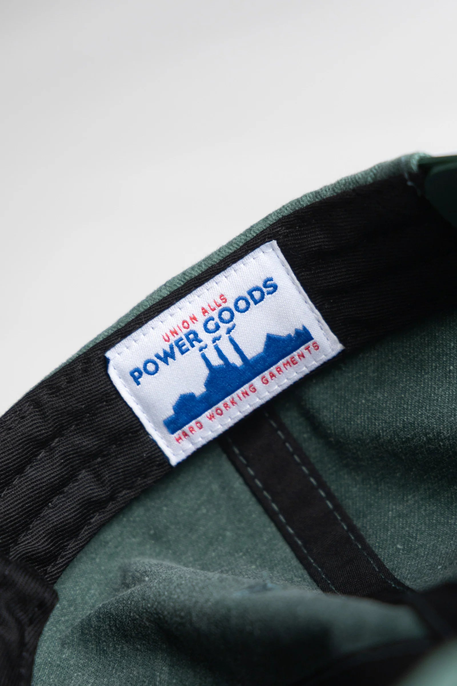 Green cap with a visible label on a light gray background