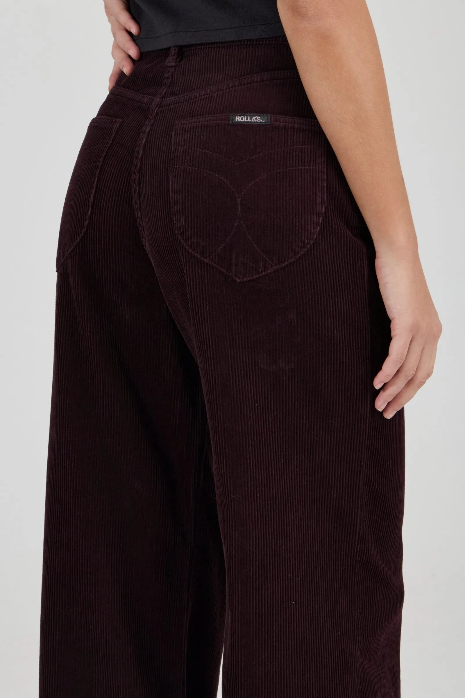 Brown corduroy pants with a visible brand label on a white background
