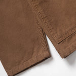 Close-up of brown pants on a white background