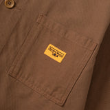 Close-up of a brown jacket with a yellow label on a matching brown background