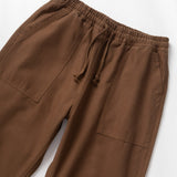 Brown pants with drawstring on a white background