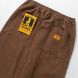 Brown pants with a visible brand label on a white background