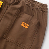 Brown pants with a logo patch on a white background