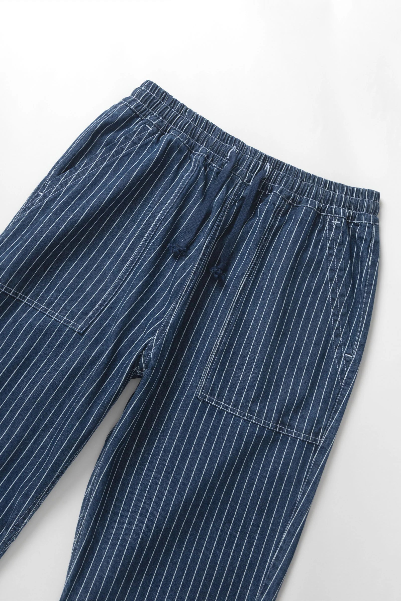 Blue pinstripe pants on a white background