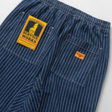Blue pinstripe pants with a visible brand label on a white background