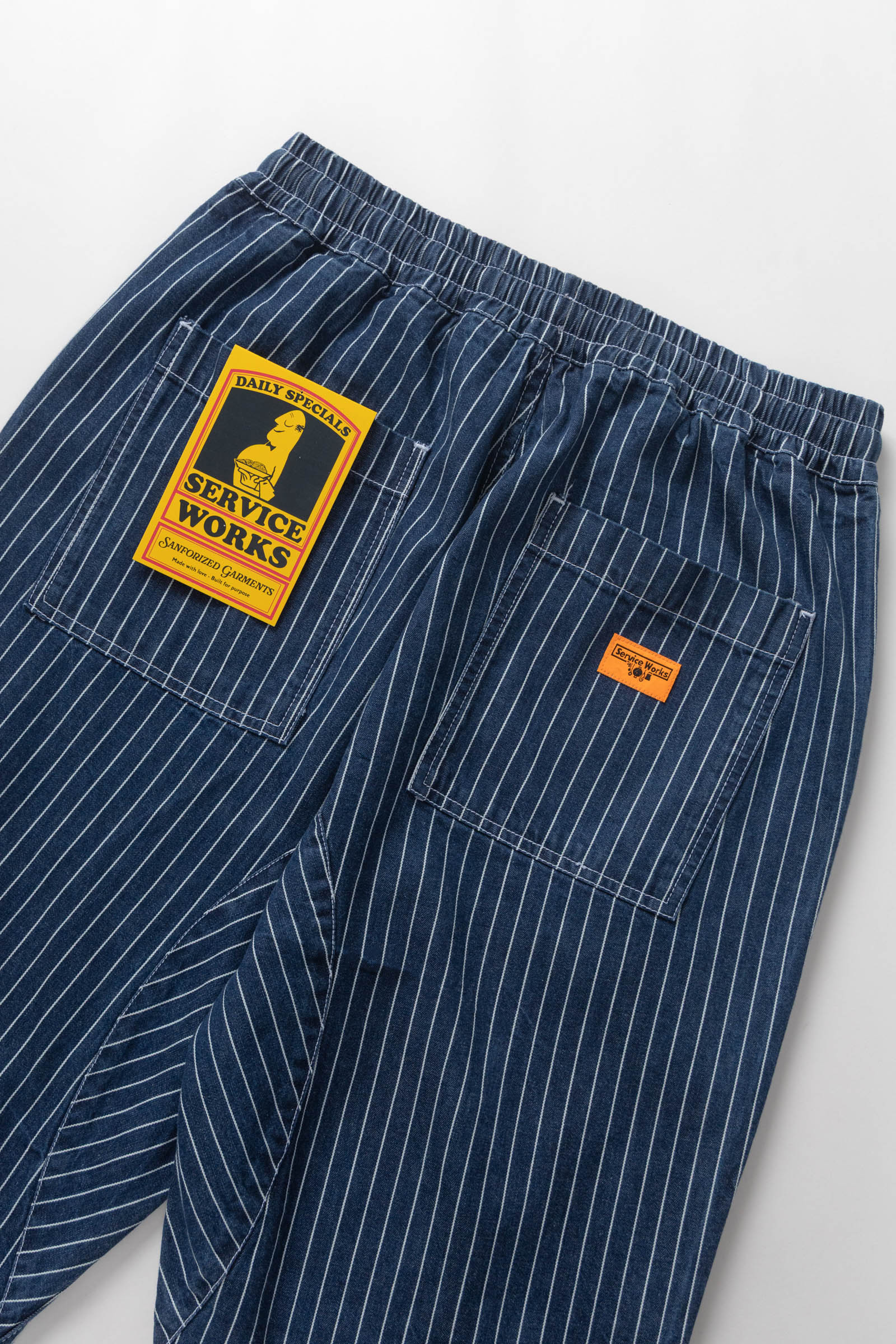Blue pinstripe pants with a visible brand label on a white background