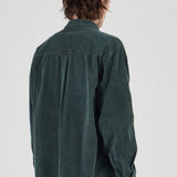Person wearing a green shirt from behind on a white background