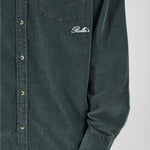 Green shirt with a brand logo on a white background