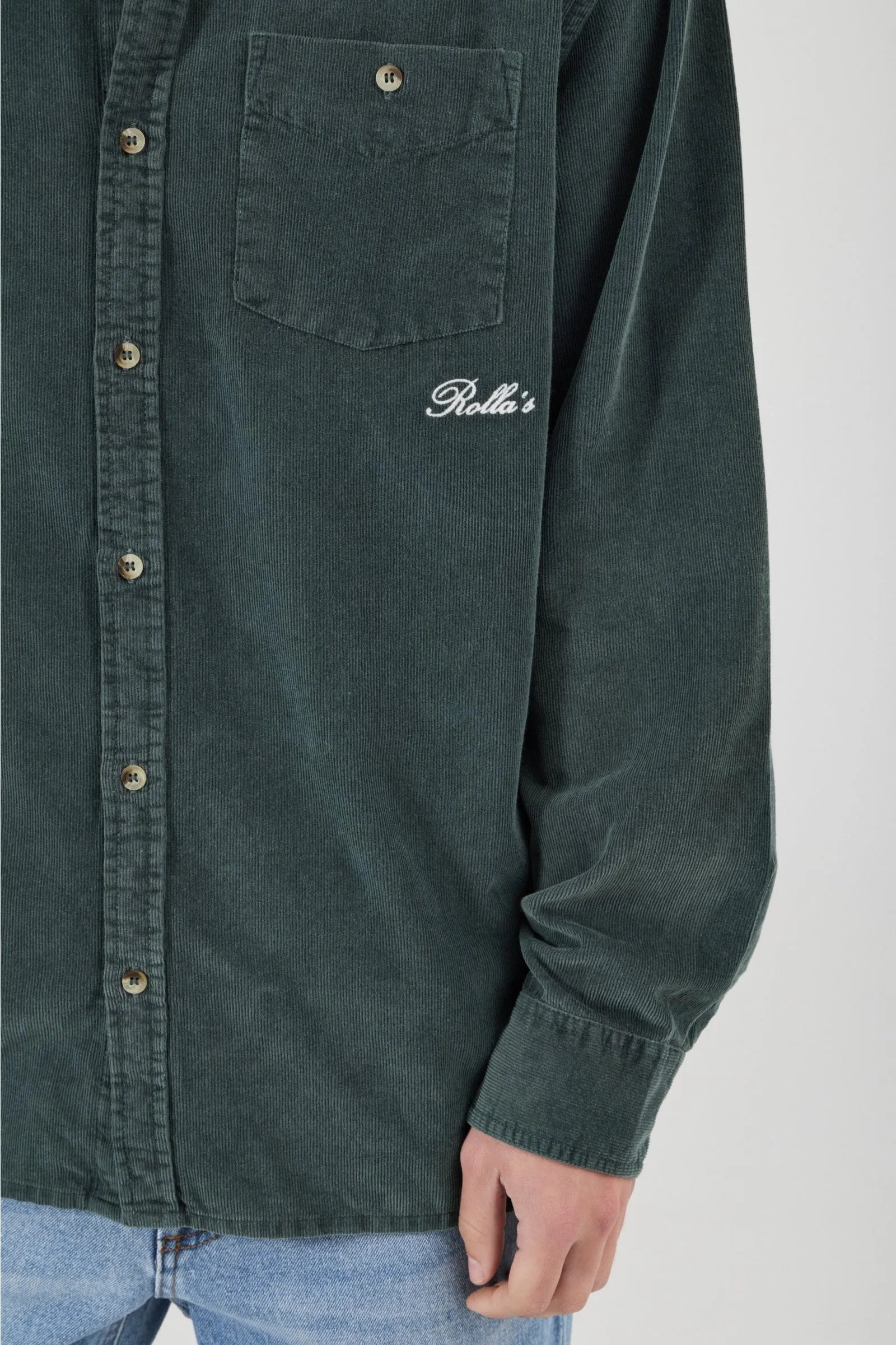 Green shirt with a brand logo on a white background