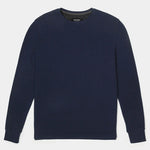 Navy blue sweater on a light gray background