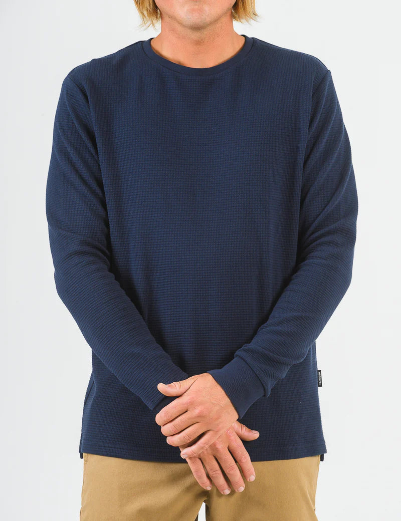 Person wearing a navy blue long-sleeve shirt on a white background