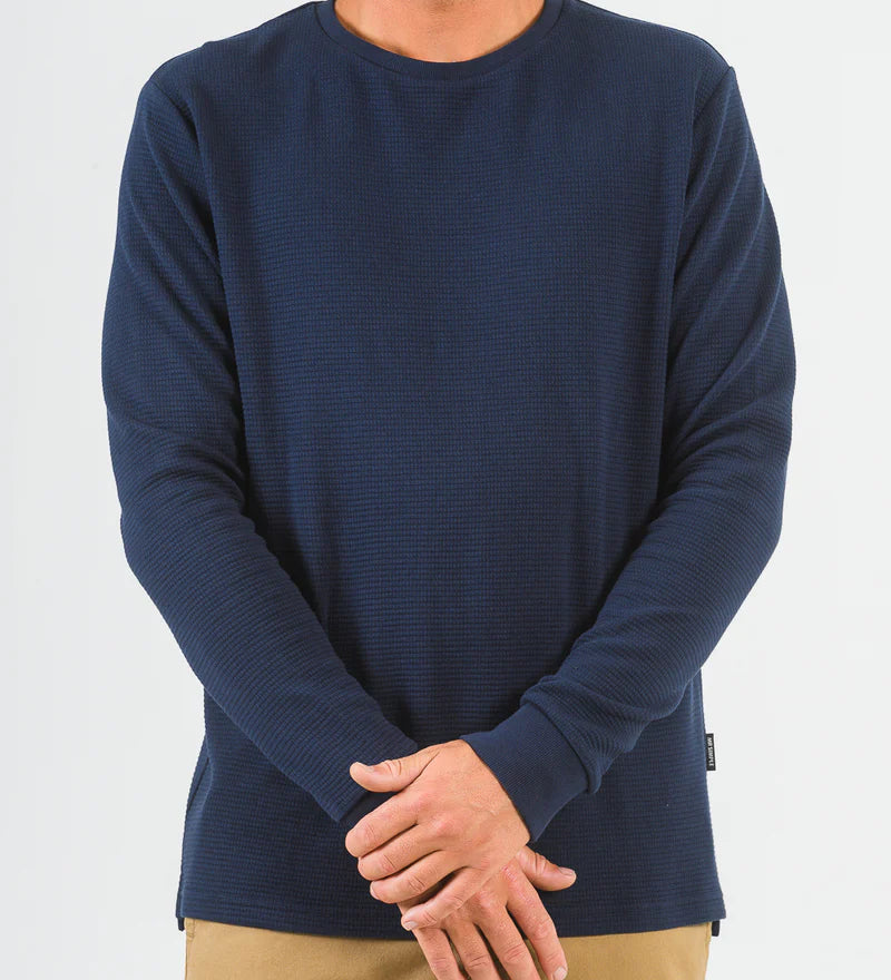 Person wearing a navy blue long-sleeve shirt on a white background
