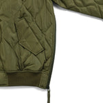 Green quilted jacket on a white background