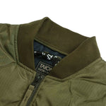 Close-up of a green jacket with a visible brand label on a white background