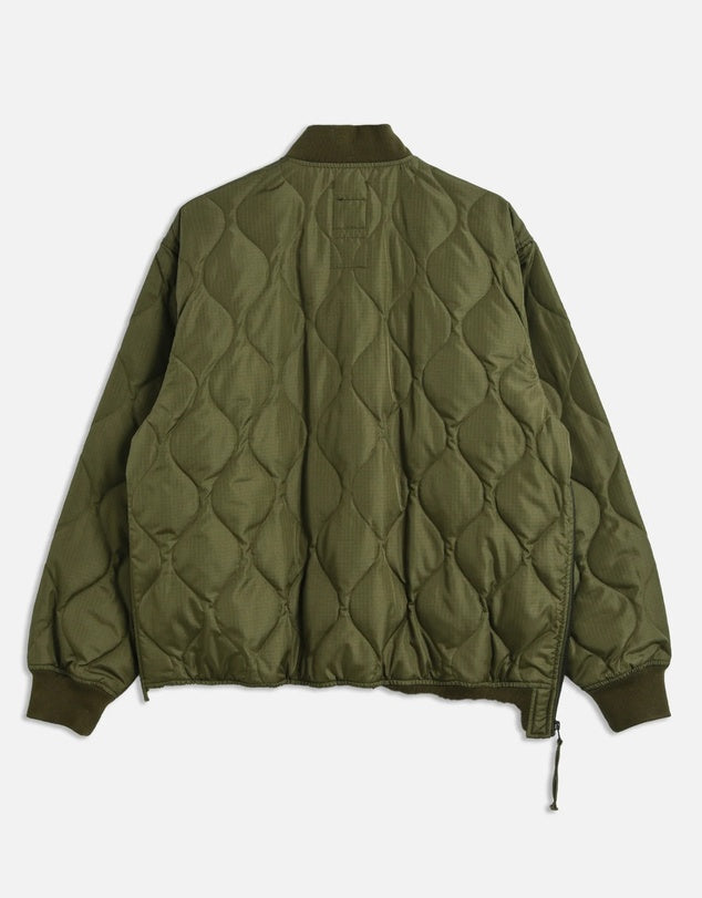 Green quilted jacket on a white background