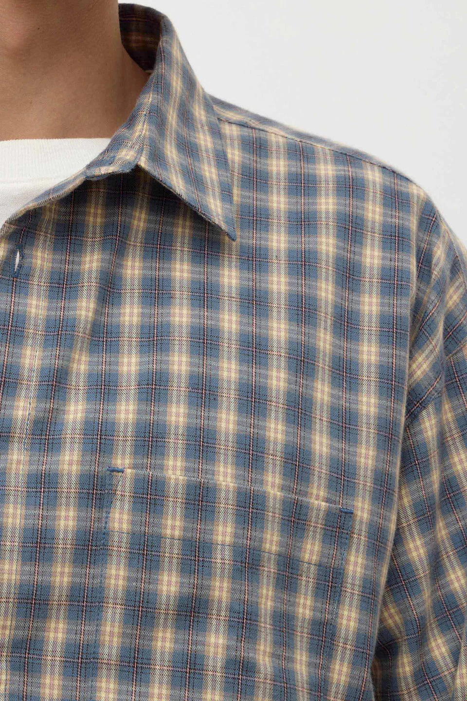 Close-up of a plaid shirt with a collar on a white background