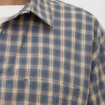 Close-up of a plaid shirt with a collar on a white background