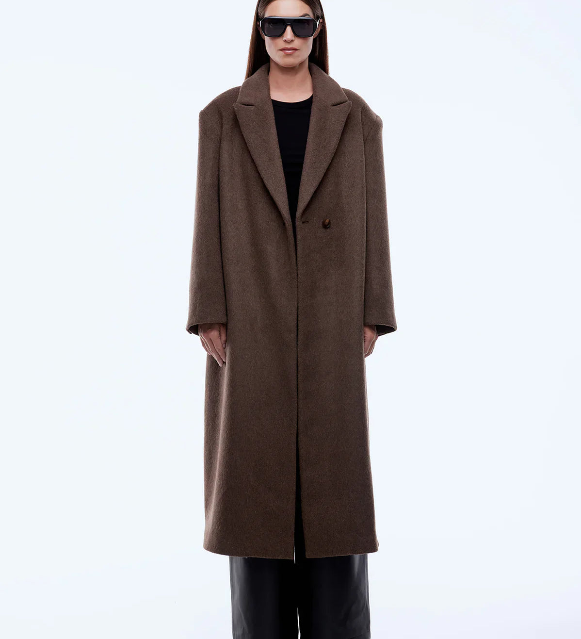 Person wearing a brown coat on a white background