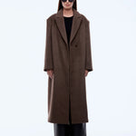 Person wearing a brown coat on a white background