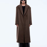 Person wearing a brown coat on a white background