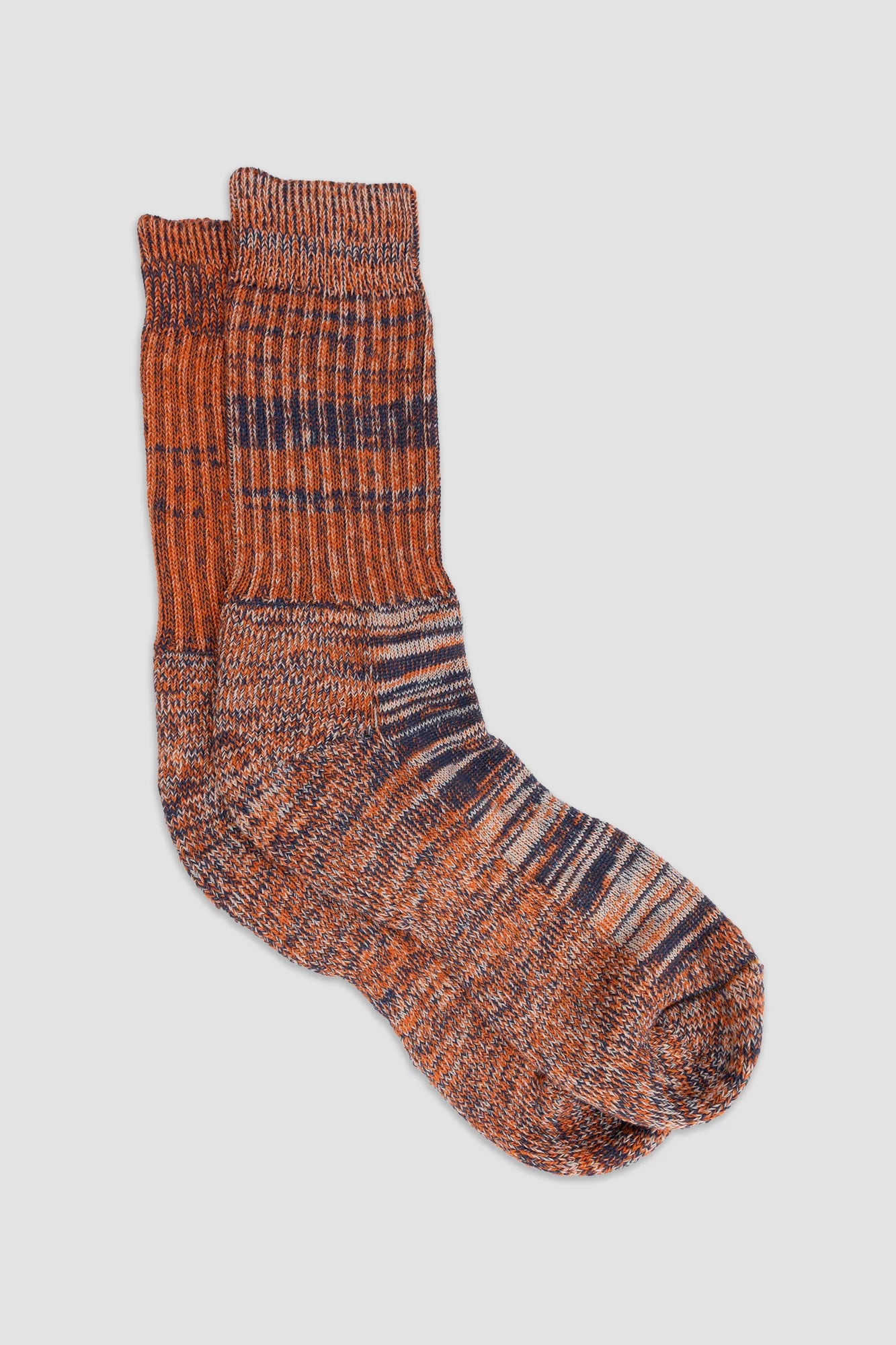 Pair of Orange and blue striped socks on a light gray background