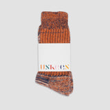 Pair of brown patterned socks with a visible brand label on a white background