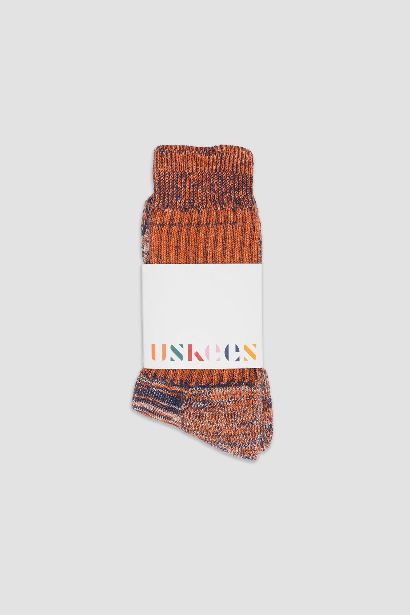 Pair of brown patterned socks with a visible brand label on a white background